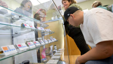 Customers shop for a variety of cannabis products on the first day legal recreational marijuana in Sonoma County at SPARC/Peace in Medicine in Sebastopol on Monday morning, January 1, 2018. (photo by John Burgess/The Press Democrat)  